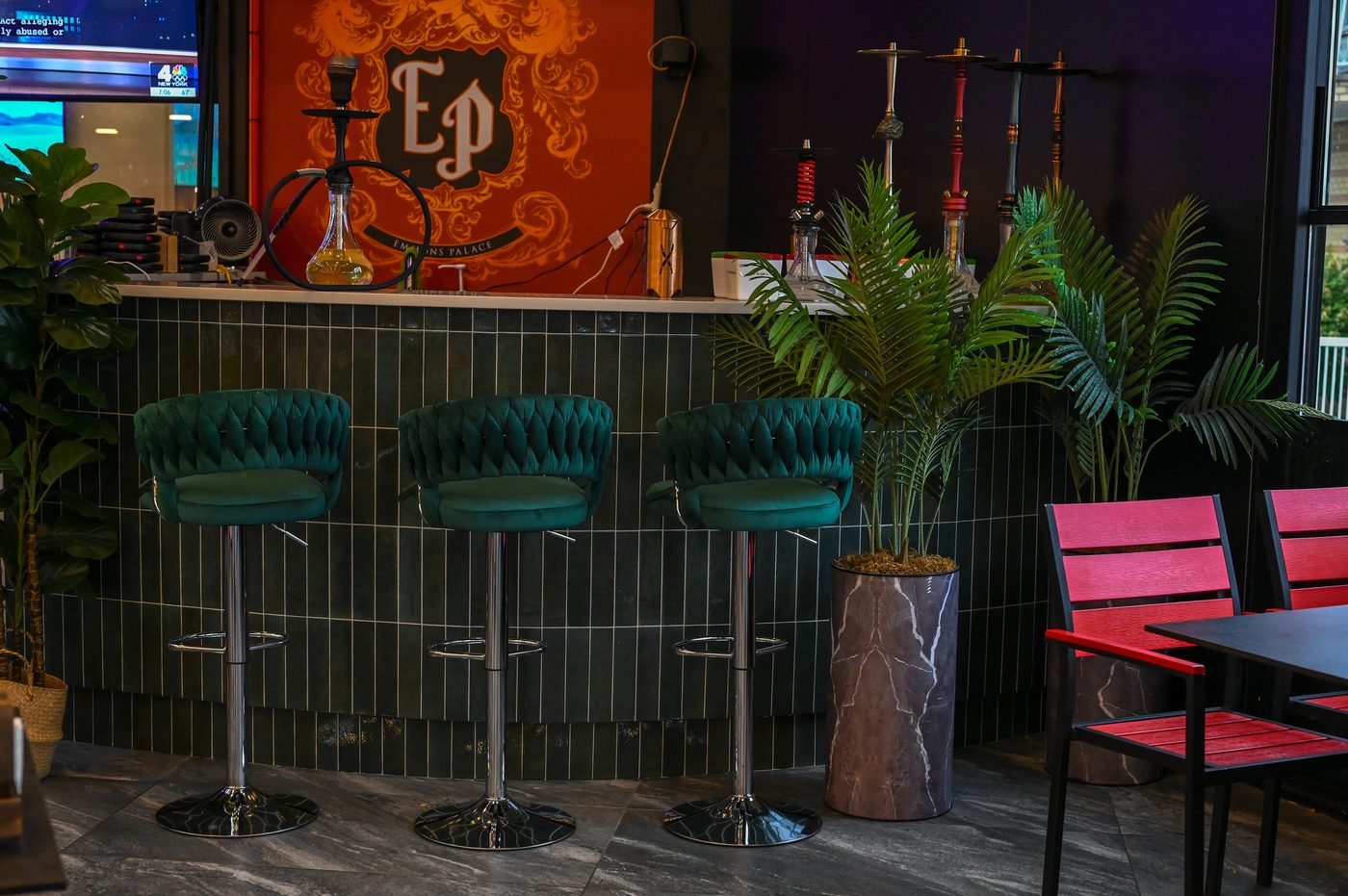 Emerald velvet stools at the open-air terrace hookah bar