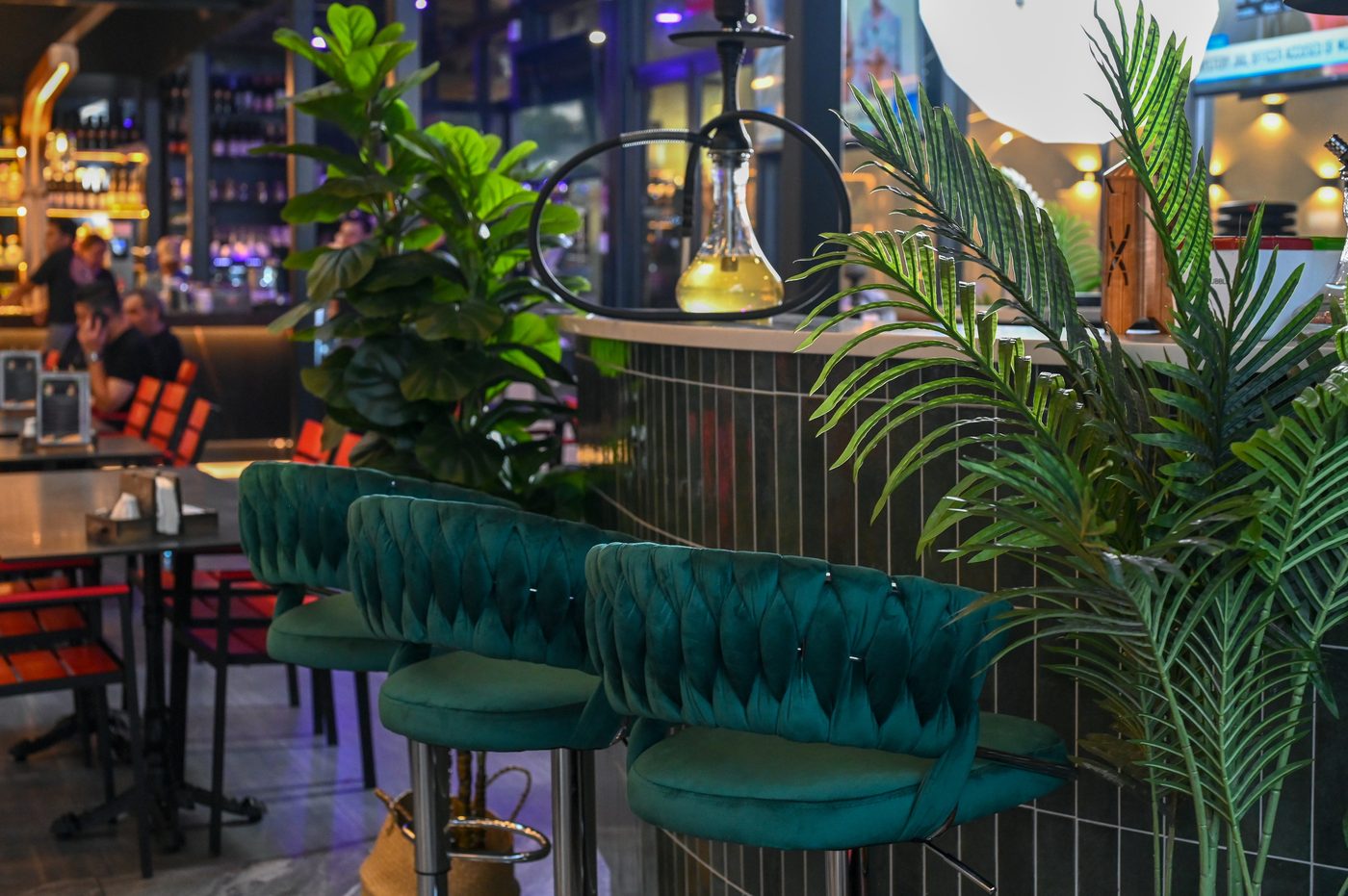 Teal velvet stools at the terrace bar